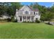 Charming two-story home with a welcoming front porch and well-manicured lawn at 1827 Shaker Falls Ln, Lawrenceville, GA 30045