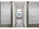Hallway view of a soaking tub and dual walk-in closets with wire shelving for optimal storage at 1827 Shaker Falls Ln, Lawrenceville, GA 30045
