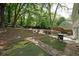 Backyard featuring a well-maintained lawn, mature trees, and a patio area at 2980 Porsche Nw Pl, Kennesaw, GA 30144