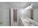 Bright bathroom featuring a double sink vanity and an adjacent open doorway at 2980 Porsche Nw Pl, Kennesaw, GA 30144