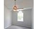 This bedroom features neutral walls and carpet plus a ceiling fan and natural light at 2980 Porsche Nw Pl, Kennesaw, GA 30144