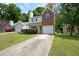 Charming two-story home with a brick facade, blue shutters, and an attached garage at 2980 Porsche Nw Pl, Kennesaw, GA 30144