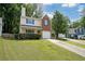 Charming two-story home with a well-manicured lawn, brick accents, and blue shutters at 2980 Porsche Nw Pl, Kennesaw, GA 30144