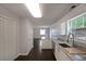 Bright kitchen with white cabinets, granite counters, stainless sink, and hardwood flooring at 2980 Porsche Nw Pl, Kennesaw, GA 30144