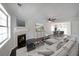 Bright living room with a fireplace, modern decor, and hardwood floors leading to a dining area at 2980 Porsche Nw Pl, Kennesaw, GA 30144