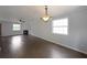 Open living area with hardwood floors, fireplace, and large windows providing natural light at 2980 Porsche Nw Pl, Kennesaw, GA 30144