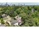 Aerial view of neighborhood with mature trees and Atlanta skyline in the distance at 3003 W Roxboro Rd, Atlanta, GA 30324