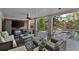 Relax on the back patio with an outdoor fireplace, comfortable seating, and a view of the pool at 3003 W Roxboro Rd, Atlanta, GA 30324