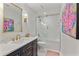 Bathroom with modern vanity, framed mirror and glass enclosed shower at 3003 W Roxboro Rd, Atlanta, GA 30324