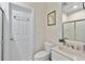 This standard bathroom features a white vanity, a toilet, and a shower with a sliding glass door at 3003 W Roxboro Rd, Atlanta, GA 30324