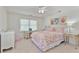 Bright bedroom with a floral-patterned comforter, desk, and vanity area at 3003 W Roxboro Rd, Atlanta, GA 30324