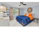 Comfortable bedroom with blue walls, ceiling fan, and ample natural light at 3003 W Roxboro Rd, Atlanta, GA 30324