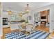 Cozy breakfast nook with modern light fixtures and a view to the fireplace at 3003 W Roxboro Rd, Atlanta, GA 30324