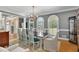 Dining room with a dark wood table, seating for ten, and large windows at 3003 W Roxboro Rd, Atlanta, GA 30324