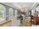 Spacious dining area with windows, a chandelier, and classic wood furnishings at 3003 W Roxboro Rd, Atlanta, GA 30324