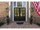 Close-up of stately front door, showcasing the address, detailed brickwork, and elegant lanterns at 3003 W Roxboro Rd, Atlanta, GA 30324