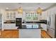 Updated kitchen with granite countertops, stainless steel appliances, and a center island at 3003 W Roxboro Rd, Atlanta, GA 30324