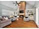 Bright living room with vaulted ceilings, brick fireplace, and built-in shelving at 3003 W Roxboro Rd, Atlanta, GA 30324