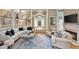 Open-concept living room with elegant furnishings, a cozy fireplace, and a seamless flow to other living spaces at 3003 W Roxboro Rd, Atlanta, GA 30324