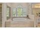 Main bathroom showcasing a large soaking tub with natural light and a separate shower at 3003 W Roxboro Rd, Atlanta, GA 30324