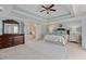 Spacious main bedroom featuring tray ceilings, ceiling fan, and a connecting en-suite bathroom at 3003 W Roxboro Rd, Atlanta, GA 30324