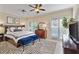 This bright main bedroom features a zebra rug, ceiling fan, and access to a deck through sliding glass doors at 3003 W Roxboro Rd, Atlanta, GA 30324