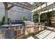 The outdoor kitchen features a built-in grill, sink, and refrigerator, perfect for entertaining at 3003 W Roxboro Rd, Atlanta, GA 30324