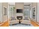 Cozy sitting area with a fireplace, comfortable armchairs, and large windows offering plenty of natural light at 3003 W Roxboro Rd, Atlanta, GA 30324