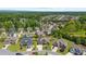 An aerial view of a neighborhood showcasing well-maintained homes, mature trees, and lush landscaping at 5950 Hidden Ridge Ct, Cumming, GA 30028