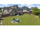 Expansive backyard featuring a fire pit area, lush lawn, and privacy fence, ideal for outdoor activities and relaxation at 5950 Hidden Ridge Ct, Cumming, GA 30028
