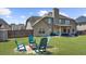 Large backyard with a patio, outdoor seating, and a well-maintained lawn, offering plenty of space for activities at 5950 Hidden Ridge Ct, Cumming, GA 30028