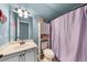 Powder blue bathroom featuring a single sink vanity and a toilet at 5950 Hidden Ridge Ct, Cumming, GA 30028