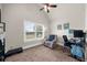 Comfortable bedroom featuring neutral walls and carpet, a window view, and a desk for a functional workspace at 5950 Hidden Ridge Ct, Cumming, GA 30028