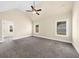 The primary bedroom has neutral walls, two windows, and plush carpet at 5950 Hidden Ridge Ct, Cumming, GA 30028