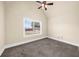 Bright bedroom with a neutral color palette, featuring a large window and ceiling fan at 5950 Hidden Ridge Ct, Cumming, GA 30028