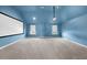 The spacious bonus room has plush carpet, and a mounted projector setup at 5950 Hidden Ridge Ct, Cumming, GA 30028