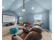 Bonus room featuring movie screen, projector, sofa, and workout equipment at 5950 Hidden Ridge Ct, Cumming, GA 30028