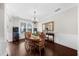 Elegant dining room with hardwood floors, wainscoting, and a chandelier at 5950 Hidden Ridge Ct, Cumming, GA 30028