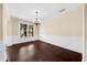 Elegant dining room showcasing hardwood floors, chandelier and a large window at 5950 Hidden Ridge Ct, Cumming, GA 30028