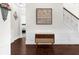 Entryway featuring a table and staircase, with a view into a bedroom at 5950 Hidden Ridge Ct, Cumming, GA 30028