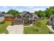 Charming brick home with a well-kept lawn, mature trees, and a spacious driveway leading to a three-car garage at 5950 Hidden Ridge Ct, Cumming, GA 30028