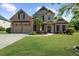 Charming two-story brick home with a well-manicured lawn and inviting curb appeal at 5950 Hidden Ridge Ct, Cumming, GA 30028
