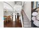 Bright foyer with hardwood floors, staircase, and views into the dining and living areas at 5950 Hidden Ridge Ct, Cumming, GA 30028