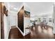 Open hallway leading into the kitchen with hardwood floors and natural light from a window at 5950 Hidden Ridge Ct, Cumming, GA 30028