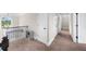 Carpeted second story hallway featuring a desk at 5950 Hidden Ridge Ct, Cumming, GA 30028