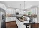 Kitchen with white cabinets, stainless steel appliances and a center island with barstool seating at 5950 Hidden Ridge Ct, Cumming, GA 30028
