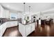 Open-concept kitchen featuring stainless steel appliances, white cabinetry, granite counter tops, and an island at 5950 Hidden Ridge Ct, Cumming, GA 30028
