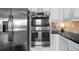 Gourmet kitchen showcasing stainless steel appliances and sleek cabinetry, offering modern convenience at 5950 Hidden Ridge Ct, Cumming, GA 30028