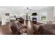 Open-concept living room with a fireplace, hardwood floors, and a view into the kitchen at 5950 Hidden Ridge Ct, Cumming, GA 30028