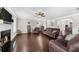 Spacious living room with hardwood floors, a fireplace, ceiling fan and comfortable seating at 5950 Hidden Ridge Ct, Cumming, GA 30028